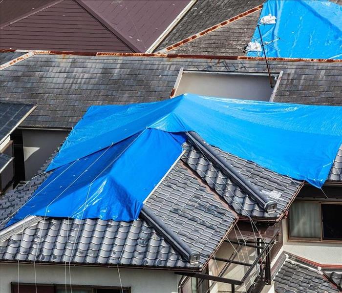 Tarps cover damaged roofs